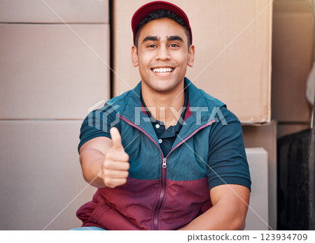 Delivery, thumbs up and courier man, shipping box and retail, ecommerce sales and service, employee smile in portrait. Success, worker in commercial distribution, working and supply chain business. Delivery, thumbs up and courier man, shipping box and retail, ecommerce sales and service, employee smile in portrait. Success, worker in commercial distribution, working and supply chain business. 123934709