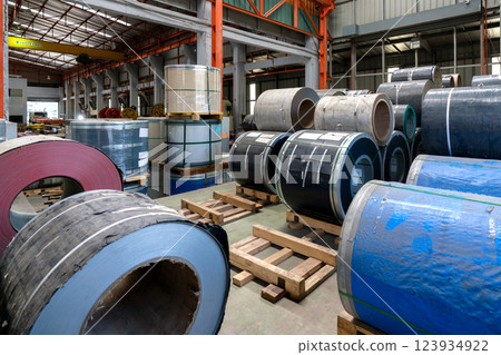 Steel coils stacked in a warehouse, ready for industrial use and distribution. 123934922
