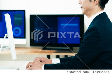 Hands of a man working on a computer Hands of a man working on a computer 123935854