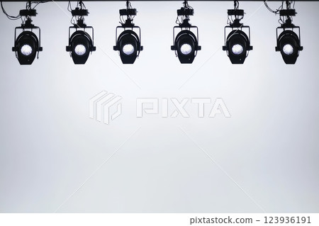 Black stage lights, evenly spaced. 123936191