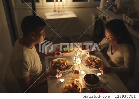 Couple enjoying romantic candlelit dinner at home Couple enjoying romantic candlelit dinner at home 123936791