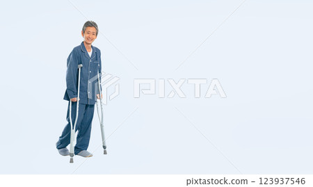 Full body photo of a senior man walking on crutches Full body photo of a senior man walking on crutches 123937546