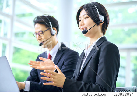 Businessman working in a call center Businessman working in a call center 123938084