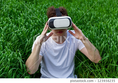 a man sits in virtual reality glasses 123938235