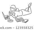 A woman eating snacks while looking at a laptop at home 123938325