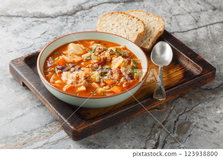 Italian sausages cabbage tomato soup with vegetables close-up in a bowl. Horizontal 123938800