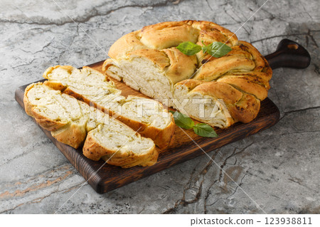 Fresh basil pesto braided bread close-up on wooden board. Horizontal 123938811