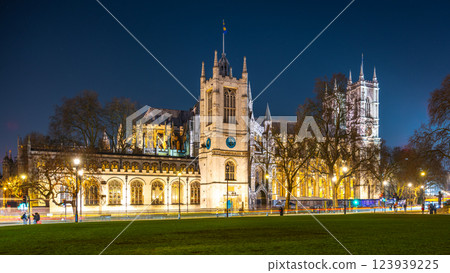 Westminster Abbey stands majestically under the night sky in London, showcasing its intricate architecture and historical significance, while nearby trees and streetlights create a serene atmosphere. 123939225