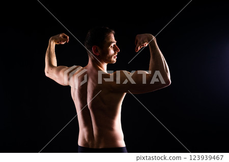Portrait, happy man and bodybuilder with abs on studio background, backdrop and topless pride 123939467