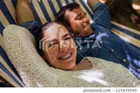 A young married couple is relaxing in the backyard of the house 123939549