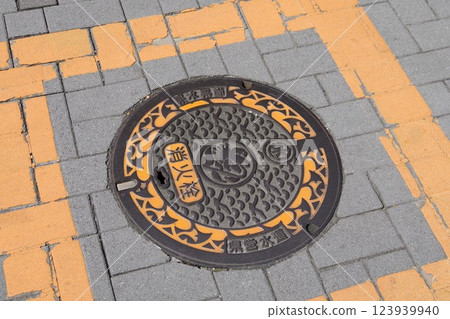 A manhole cover of Kanagawa Prefecture featuring the prefecture's bird, the seagull, the prefecture's flower, the mountain lily, and the prefecture's tree, the ginkgo. A manhole cover of Kanagawa Prefecture featuring the prefecture's bird, the seagull, the prefecture's flower, the mountain lily, and the prefecture's tree, the ginkgo. 123939940