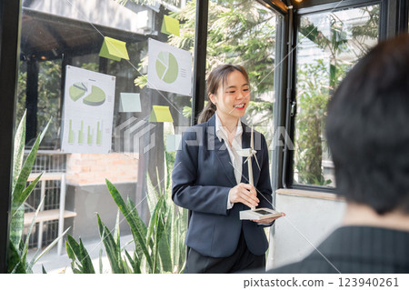 Sustainability Discussion and Team Collaboration. A professional explaining sustainable business practices to colleagues during a strategy session. 123940261