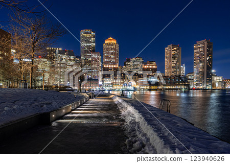 View of Boston downtown  skyscrapers seen from Fan Pier Park on a cold cloudy winter night 123940626