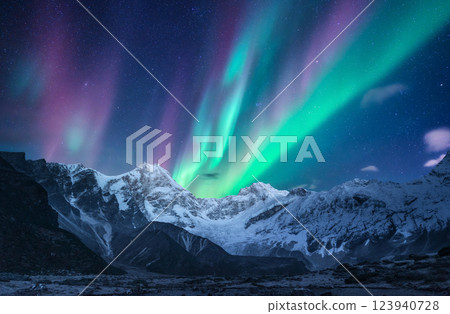 Northern lights over the snowy mountains at night in Norway Northern lights over the snowy mountains at night in Norway 123940728