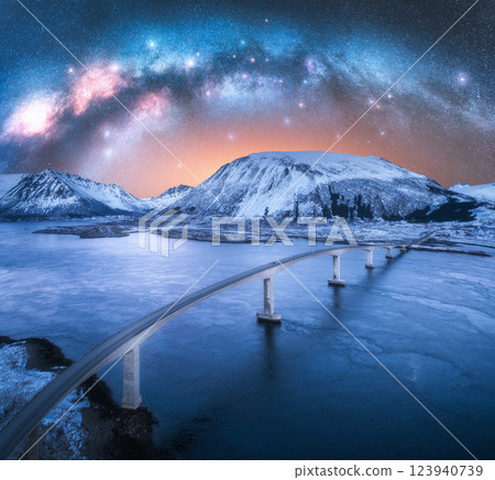 Aerial view of Milky Way, bridge, fjord, snowy mountains at night Aerial view of Milky Way, bridge, fjord, snowy mountains at night 123940739