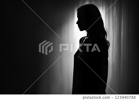 Illuminated silhouette of a woman in the dark 123940788