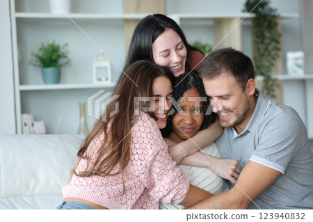 Overwhelmed woman being hugged by friends 123940832
