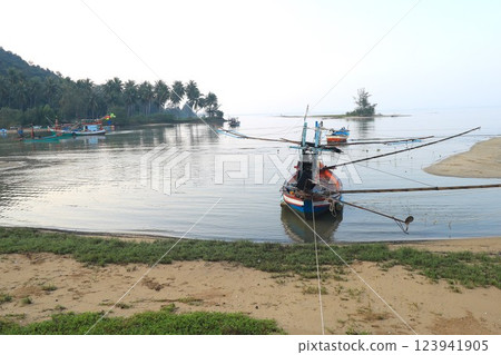 Thai fishing boat parked on calm sea 123941905