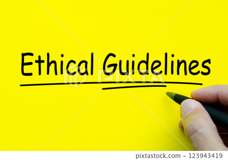Hand written text about Ethical Guidelines on yellow notepad Hand written text about Ethical Guidelines on yellow notepad 123943419
