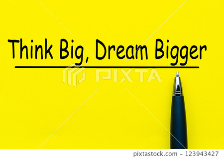 Think Big and Dream Bigger text on yellow cover background 123943427