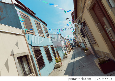 Festive bunting and lanterns decorate a narrow street for summer festival in June San Juan 123943693