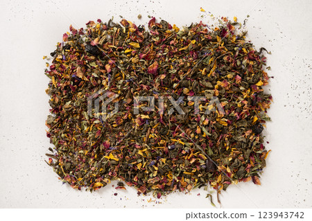 Pile of dry herbal tea and flowers green tea on white background. View from above. Dry tea leaves texture. 123943742