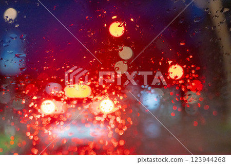 Rainy Night Traffic Through a Wet Windshield View 123944268