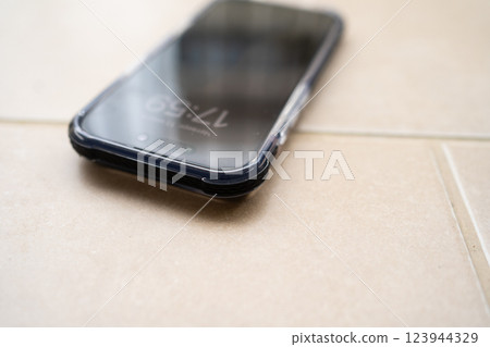 Smartphone in shockproof silicone case on tiled floor after falling. 123944329
