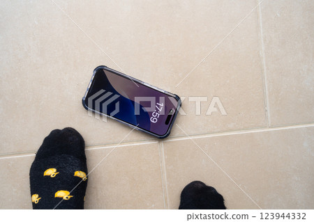 Smartphone in shockproof silicone case on tiled floor after falling. 123944332