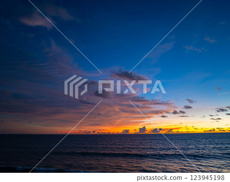 Aerial view of Vibrant Sunset Over Ocean Waves Aerial view of Vibrant Sunset Over Ocean Waves 123945198