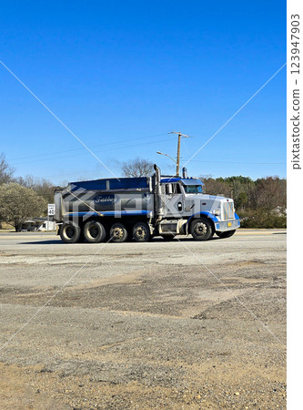Freight liner Semi-Truck Driving on Open Highway in a Rural Area, CDL Truck showcasing commercial transportation, logistics efficiency, and professional trucking Freight liner Semi-Truck Driving on Open Highway in a Rural Area, CDL Truck showcasing commercial transportation, logistics efficiency, and professional trucking 123947903