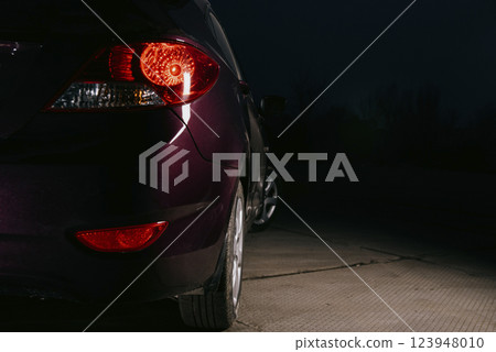 Rear of a dark burgundy car. Rear of a dark burgundy car. 123948010