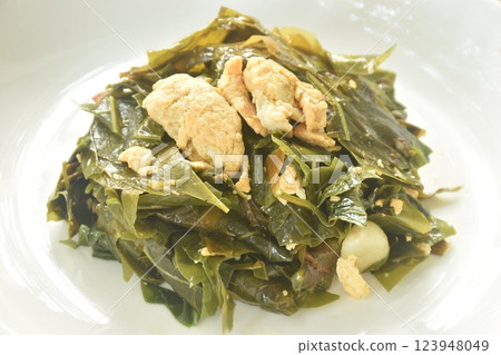 fried Melinjo tropical vegetable with egg on plate fried Melinjo tropical vegetable with egg on plate 123948049