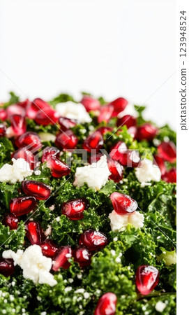 kale salad with pomegranate seeds, goat cheese, and citrus dressing, isolated on a white background, showcasing fresh ingredients and vibrant colors, concept of healthy food, organic nutrition, diet 123948524