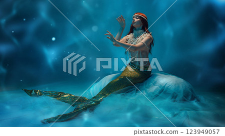 Fantasy touch. Beautiful young woman, graceful mermaid sitting in tender pose deep in the ocean with wavy pattern and soft lights. Fantasy touch. Beautiful young woman, graceful mermaid sitting in tender pose deep in the ocean with wavy pattern and soft lights. 123949057