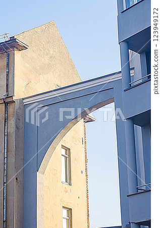 Architectural detail of two buildings connected by an archway, contrasting colors, sunny day. High quality photo Architectural detail of two buildings connected by an archway, contrasting colors, sunny day. High quality photo 123949172