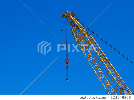 A crane extending into the blue sky 123949866