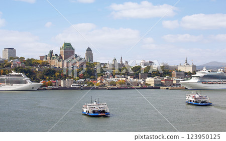 Quebec City skyline in autumn with two ferries crossing Saint Lawrence River in autumn  123950125