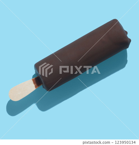 chocolate popsicle with ice cream and hard shadow on blue background, creative decoration of summer concept 123950134