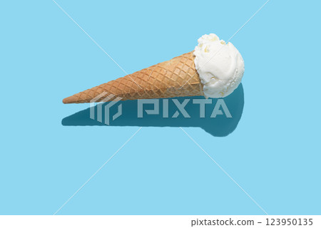 vanilla ice cream and hard shadow on blue background, creative decoration of minimal summer concept 123950135