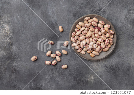 Plate full of dried pinto beans on gray top view, copy space. Traditional Latin American legumes 123951077