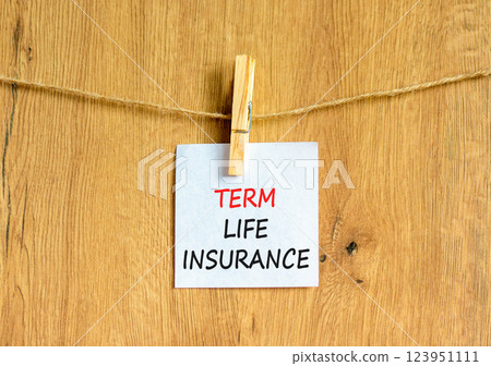 Term life insurance symbol. Concept words Term life insurance on beautiful white paper on clothespin. Beautiful wooden background. Business term life insurance concept. Copy space. 123951111
