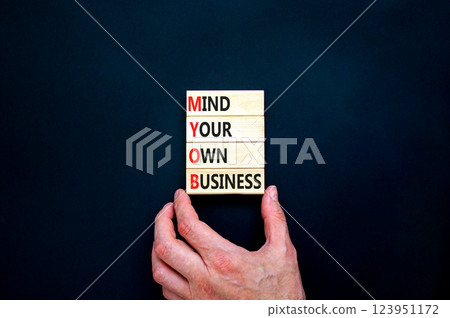 MYOB mind your own business symbol. Concept word MYOB Mind Your Own Business on beautiful wooden blocks. Beautiful black background. Business MYOB mind your own business concept. Copy space. 123951172