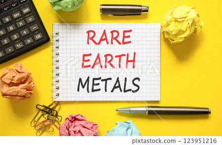 Rare earth metals symbol. Concept words Rare earth metals on beautiful white note. Black pen. Calculator. Beautiful yellow background. Business and rare earth metals concept. Copy space. 123951216