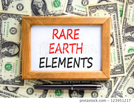 Rare earth elements symbol. Concept words Rare earth elements on beautiful wooden picture frame. Black pen. Beautiful background from dollar bills. Business and rare earth elements concept. Copy space Rare earth elements symbol. Concept words Rare earth elements on beautiful wooden picture frame. Black pen. Beautiful background from dollar bills. Business and rare earth elements concept. Copy space 123951217