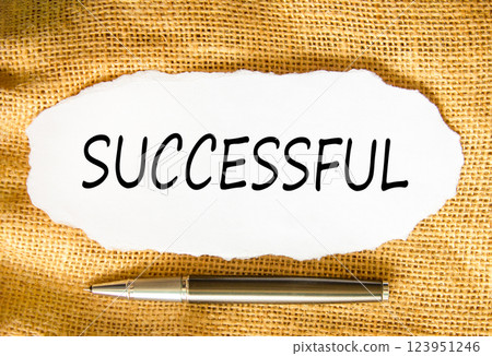 Successful symbol. Concept word Successful on beautiful white paper. Beautiful canvas background. Beautiful black pen. Business successful concept. Copy space. 123951246