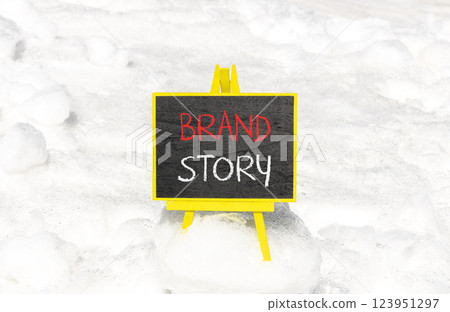Brand story branding symbol. Concept words Brand story on beautiful yellow chalk blackboard. Beautiful white snow background. Business brand story branding concept. Copy space. Brand story branding symbol. Concept words Brand story on beautiful yellow chalk blackboard. Beautiful white snow background. Business brand story branding concept. Copy space. 123951297