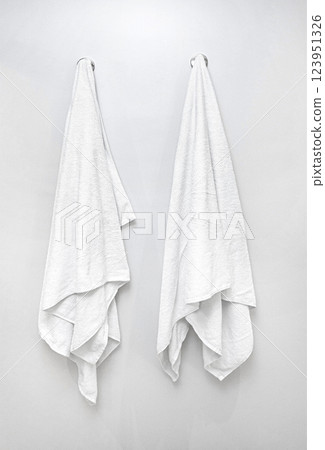Two white towels hanging on hooks in bathroom, cleanliness and hygiene concept 123951326