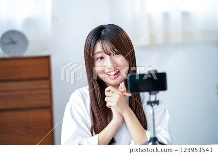 Smiling woman taking a video 123951541