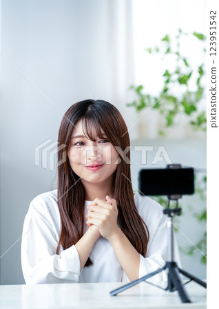 Smiling woman taking a video Smiling woman taking a video 123951542